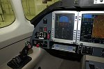 The left-hand side of the cockpit, with pilot's PFD and part of MFD in view.  Note keyboard beneath PFD.  <br><br>Brigid says they just had an industrial design engineer rework the aesthetics of the displays and keyboard mount, and plan to announce more details on the avionics this spring.  <br>Sidestick control shown here has only elevator trim switch; engineering simulator and planned production versions will include aileron trim with a &quotcoolie hat&quot switch.  