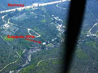 We overflew Blancaneaux Lodge prior to landing.  In this photo, the runway is the horizontal line across the top of the picture.  The river runs horizontally across the middle of the picture, with the lodge's villas alongside it.  <br><br>The arrow shows Francis Ford Coppola's villa (he designed and owns the lodge), where we stay while there.  