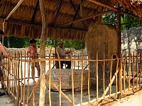 Margaret and our guide at another thatched building protecting one of the carved stellae.  