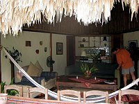 The main living area of the Coppola villa at Blancaneaux, with dining table for twelve and hammock in the foreground.  